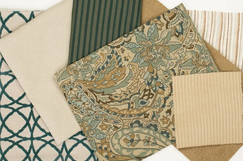 Layered patterned fabric samples and trim from Charlotte Fabrics
