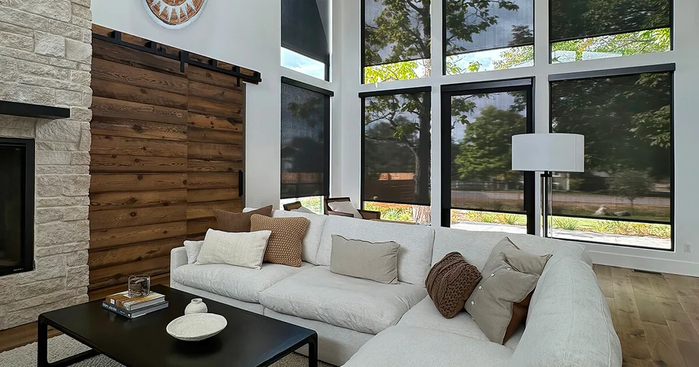 Insolroll shades on large windows in a modern living room